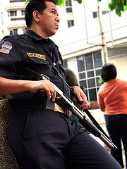 an Armed Security Guard guarding an Armored Truck